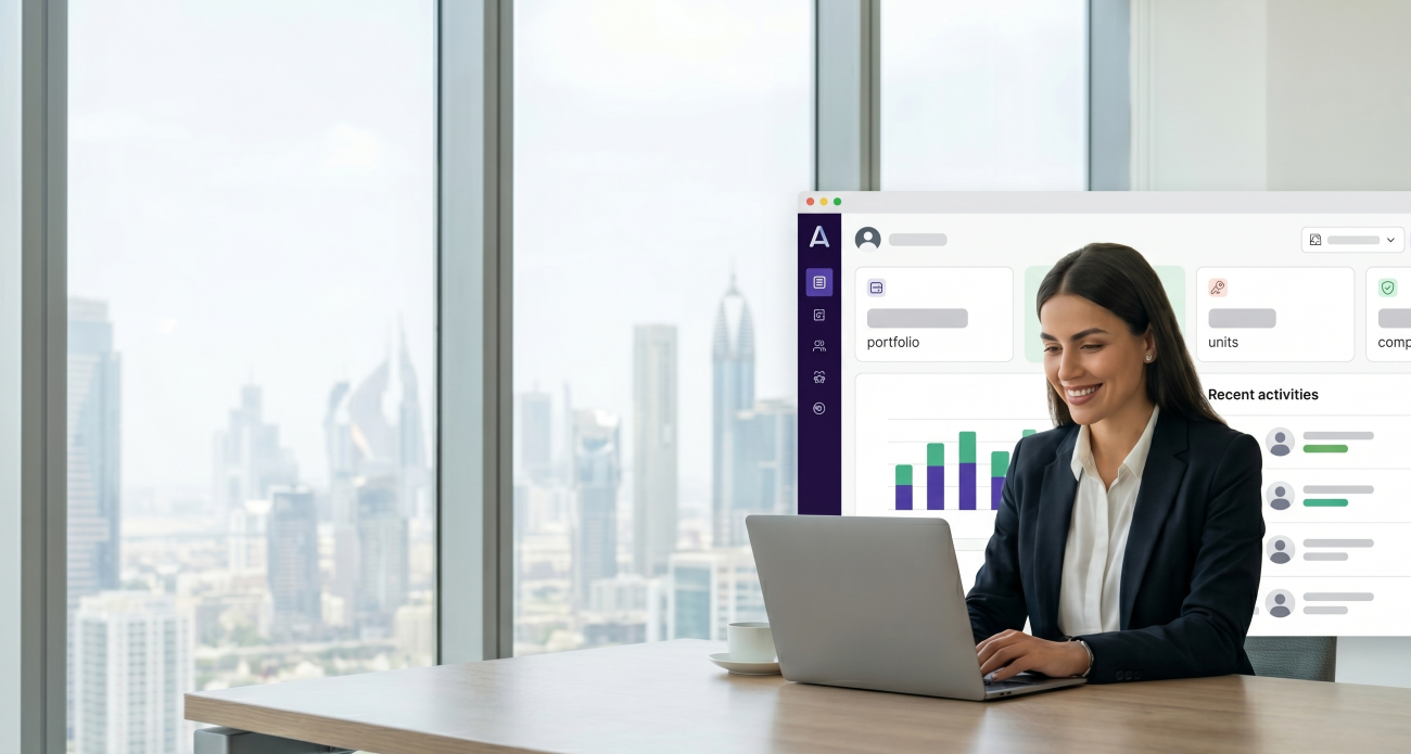 A property manager using the Aqaris dashboard on a laptop in a Dubai office